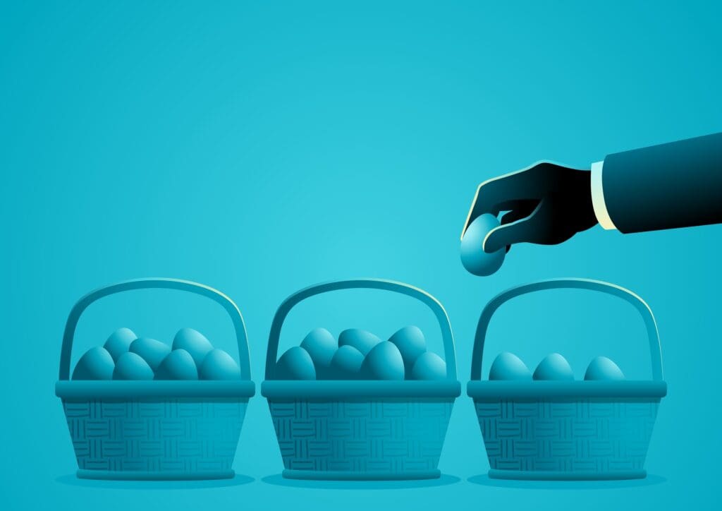 A hand picking an egg from a basket against blue background.